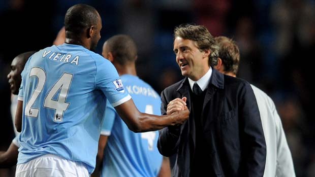 Manchester City's Patrick Vieira is congratulated by his manager Roberto Mancini in 2011.
